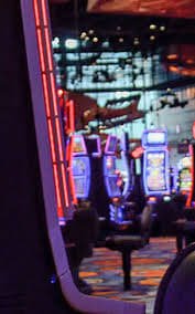 Live dealer preparing cards at a No Commission Baccarat table with multiple camera angles